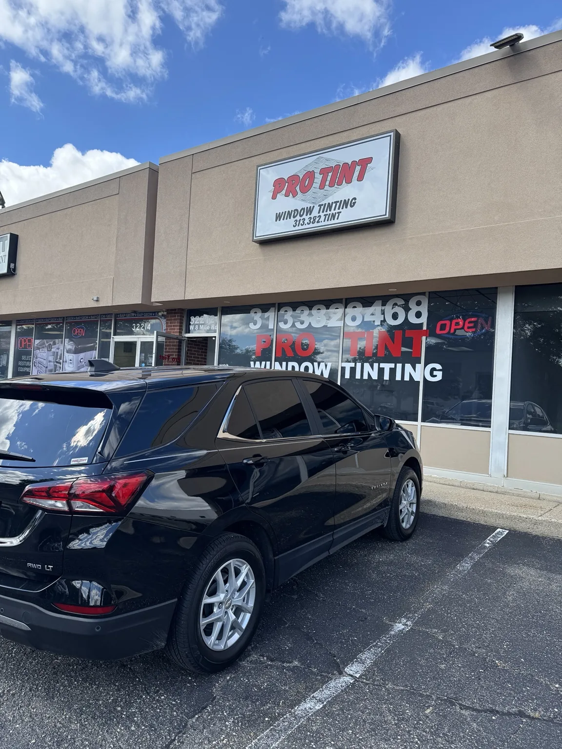 Chevrolet Equinox outside Pro Tint storefront in Farmington Hills