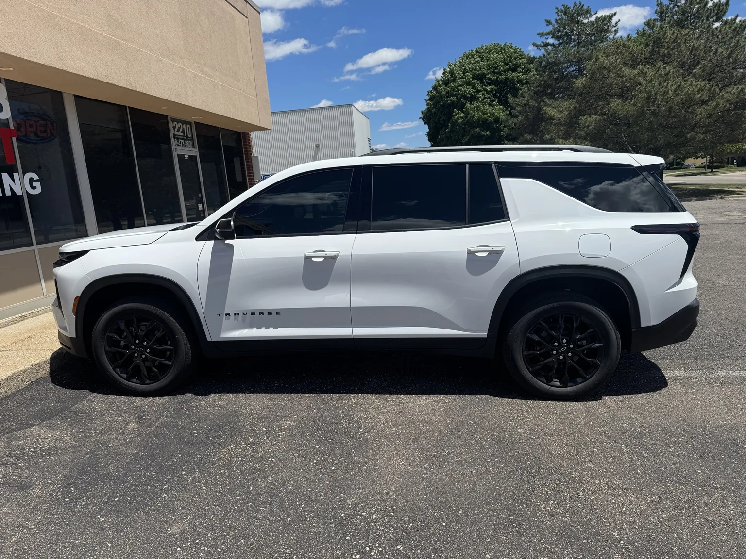 White Chevrolet Traverse with window tint