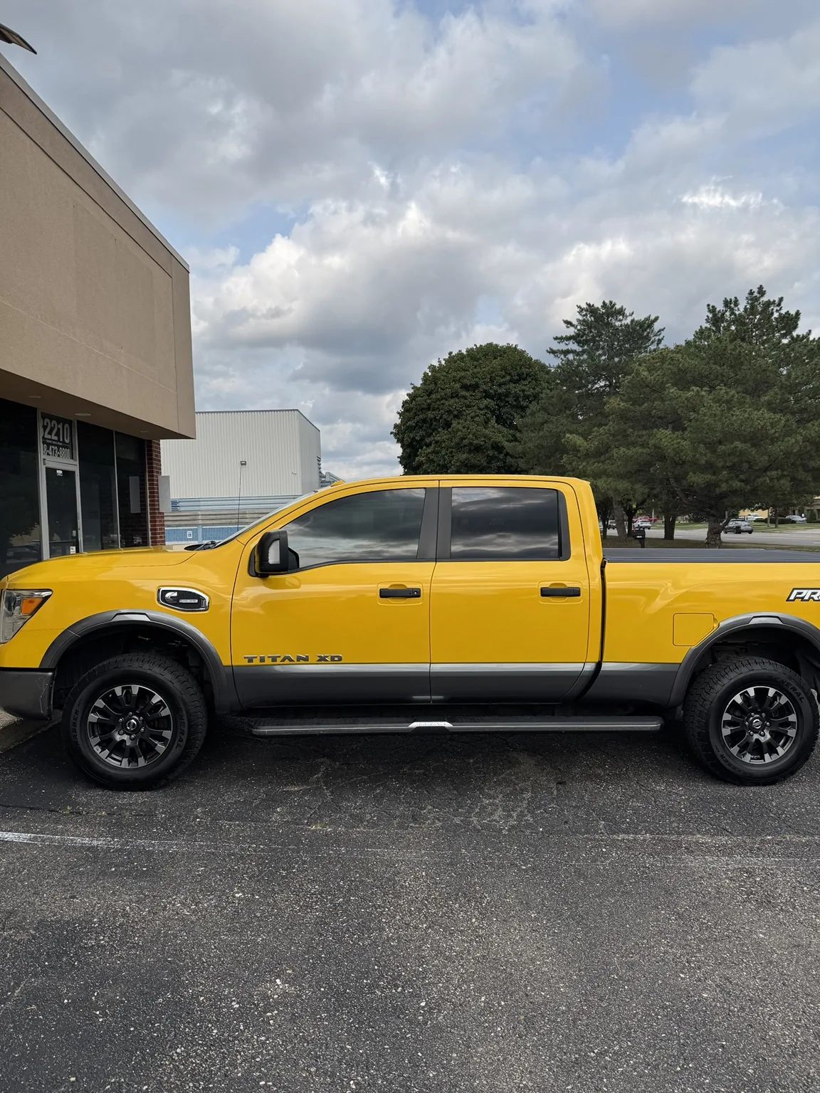 Yellow Nissan Titan pickup with window tint